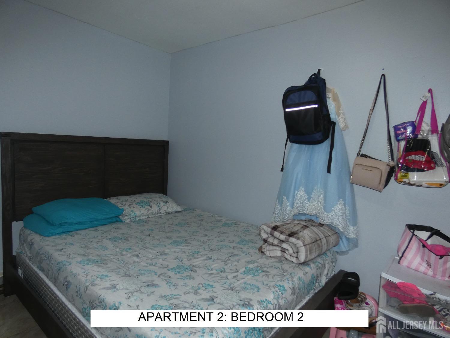 355 High Street Perth Amboy, NJ 08861 - Photo 10 of 19 a bedroom with a bed and cabinets
