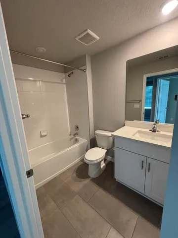 a bathroom with a sink a toilet a mirror and shower