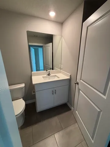 a bathroom with a sink a toilet and mirror