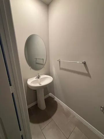 a bathroom with a sink toilet and a mirror