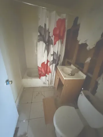 a bathroom with a sink mirror vanity and toilet