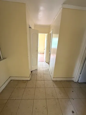 a view of a livingroom with an empty space and a window