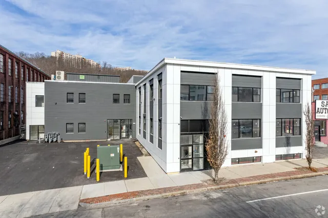 a view of a brick building next to a yard
