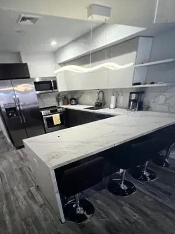 a kitchen with counter top space cabinets and appliances