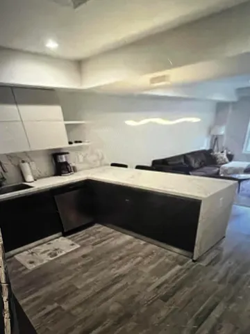 a kitchen with a sink a counter space and cabinets