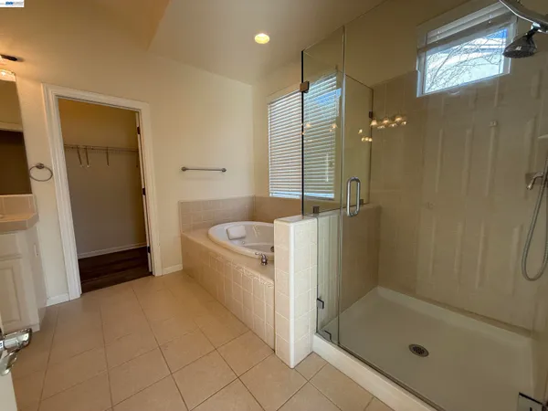 a bathroom with a tub shower and a sink
