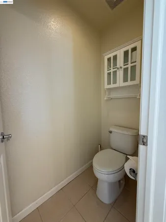 a white toilet sitting next to a bathroom sink