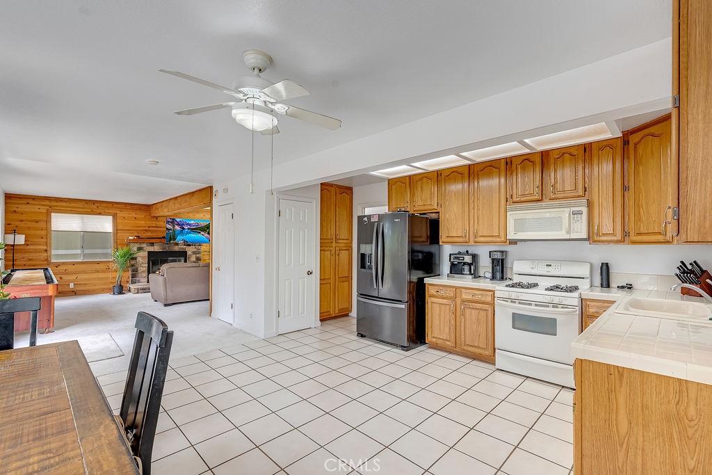 318 Old Toll Road Lake Arrowhead, CA 92352 - Photo 23 of 44 a kitchen with a sink stainless steel appliances furniture cabinets and a window