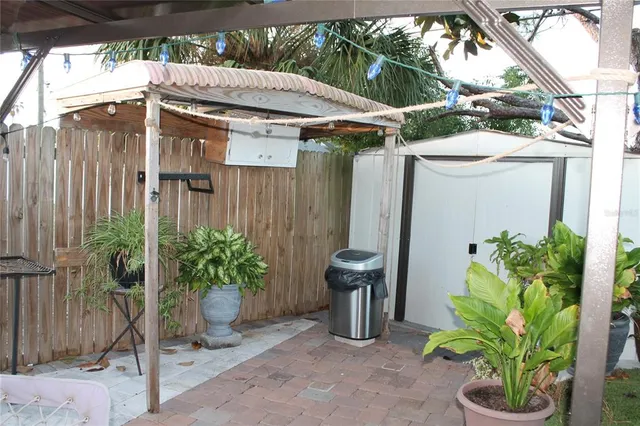 a view of a chairs and table in the back yard of the house