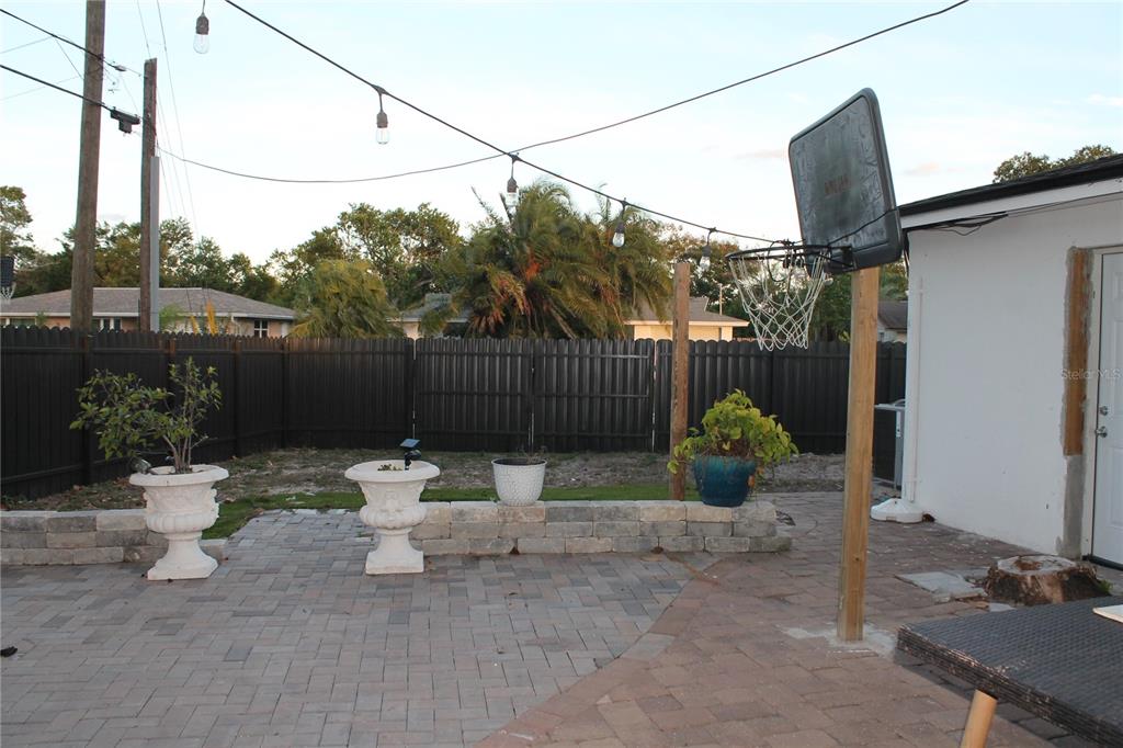 7423 Star Dust Drive Port Richey, FL 34668 - Photo 20 of 23 a view of a chair and fire pit in the backyard of a house