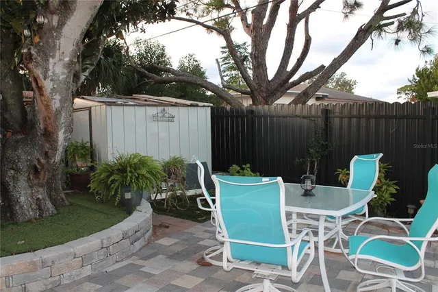 a view of a backyard with a tree