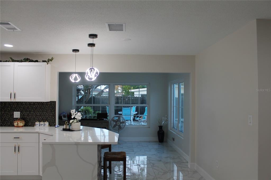 7423 Star Dust Drive Port Richey, FL 34668 - Photo 3 of 23 a view of a kitchen and dining table