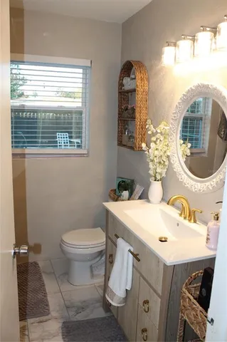 a bathroom with a toilet sink and mirror