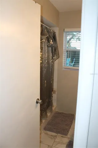 a bathroom with a glass shower door