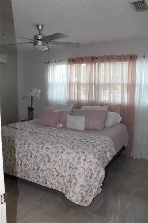7423 Star Dust Drive Port Richey, FL 34668 - Photo 6 of 23 a living room with a bed furniture and a large window