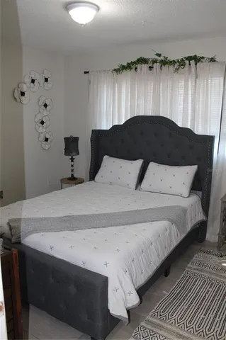 a bedroom with a bed and a lamp