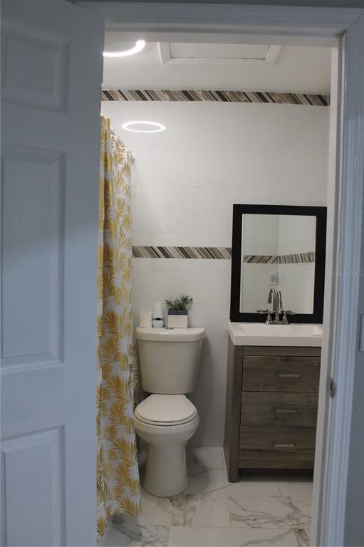 7423 Star Dust Drive Port Richey, FL 34668 - Photo 9 of 23 a bathroom with a toilet a sink and shower