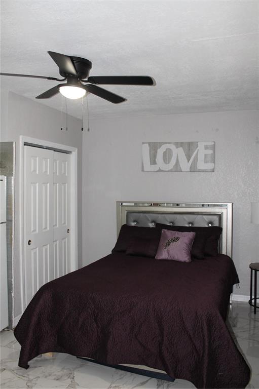 7423 Star Dust Drive Port Richey, FL 34668 - Photo 10 of 23 a bedroom with a bed and a ceiling fan