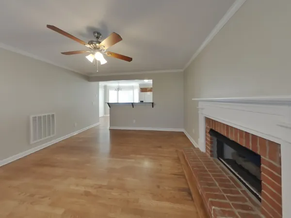 wooden floor in an empty room with a fireplace