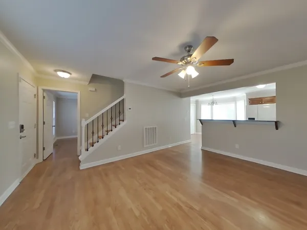 a view of an empty room with a window and a ceiling fan