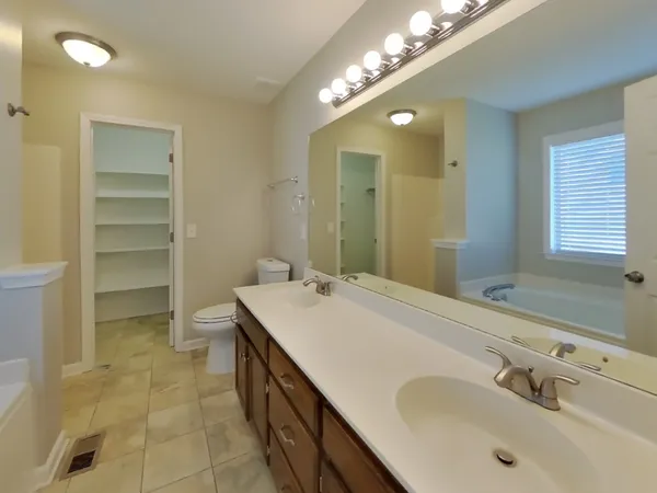 a bathroom with a sink double vanity and a mirror