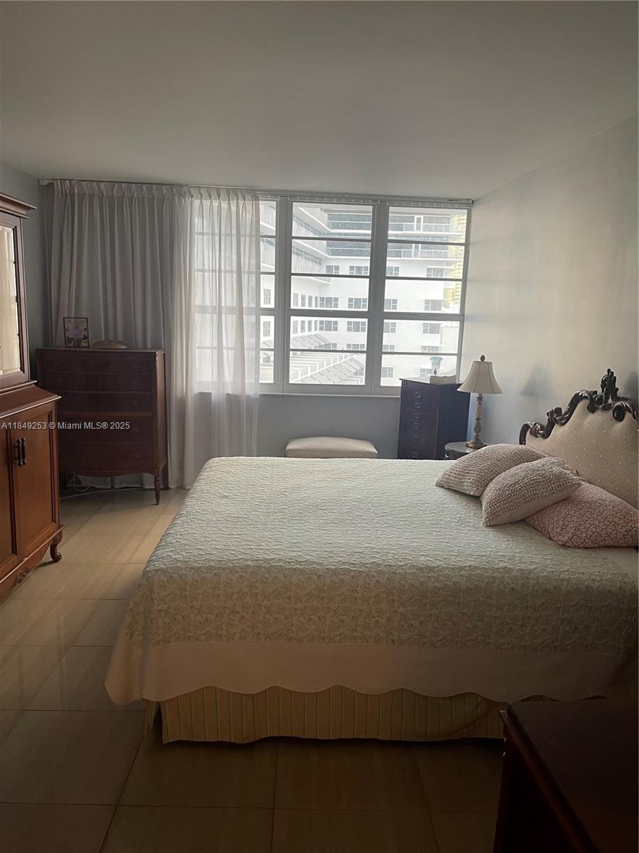 100 Lincoln Road, Unit 833 Miami Beach, FL 33139 - Photo 16 of 30 a bedroom with a bed and a couch