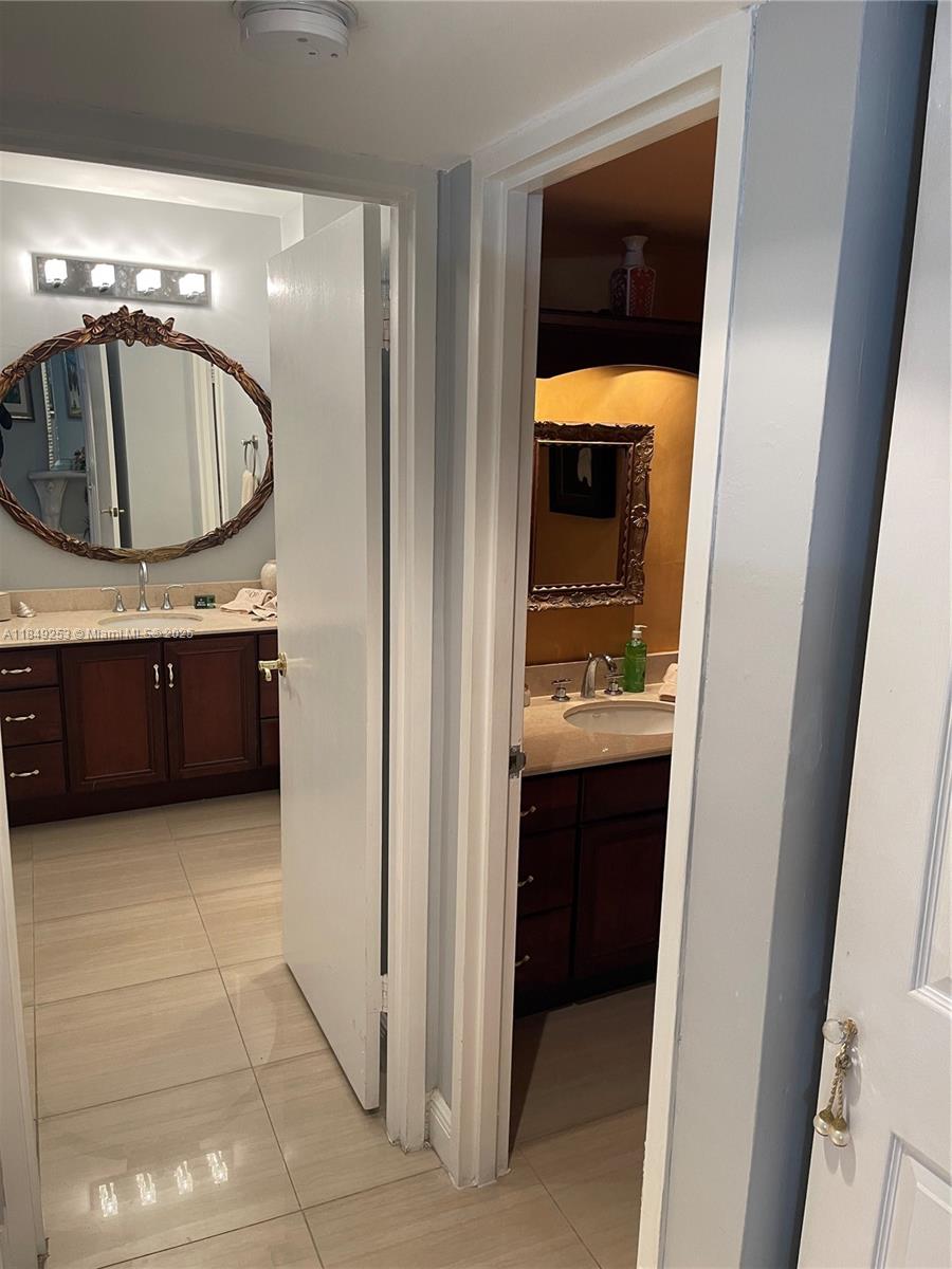 100 Lincoln Road, Unit 833 Miami Beach, FL 33139 - Photo 20 of 30 a bathroom with a sink and a mirror