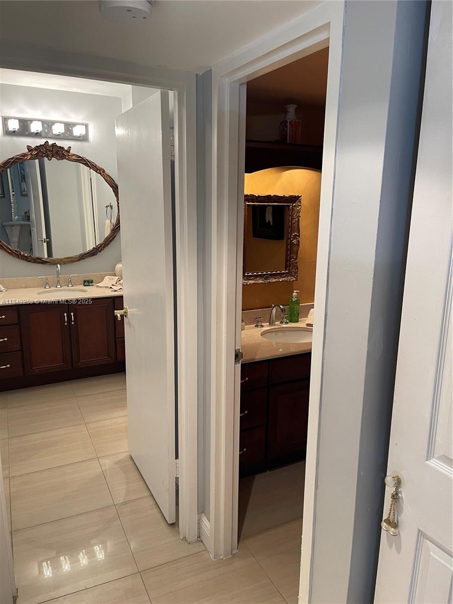 100 Lincoln Road, Unit 833 Miami Beach, FL 33139 - Photo 21 of 30 a bathroom with a sink and a mirror