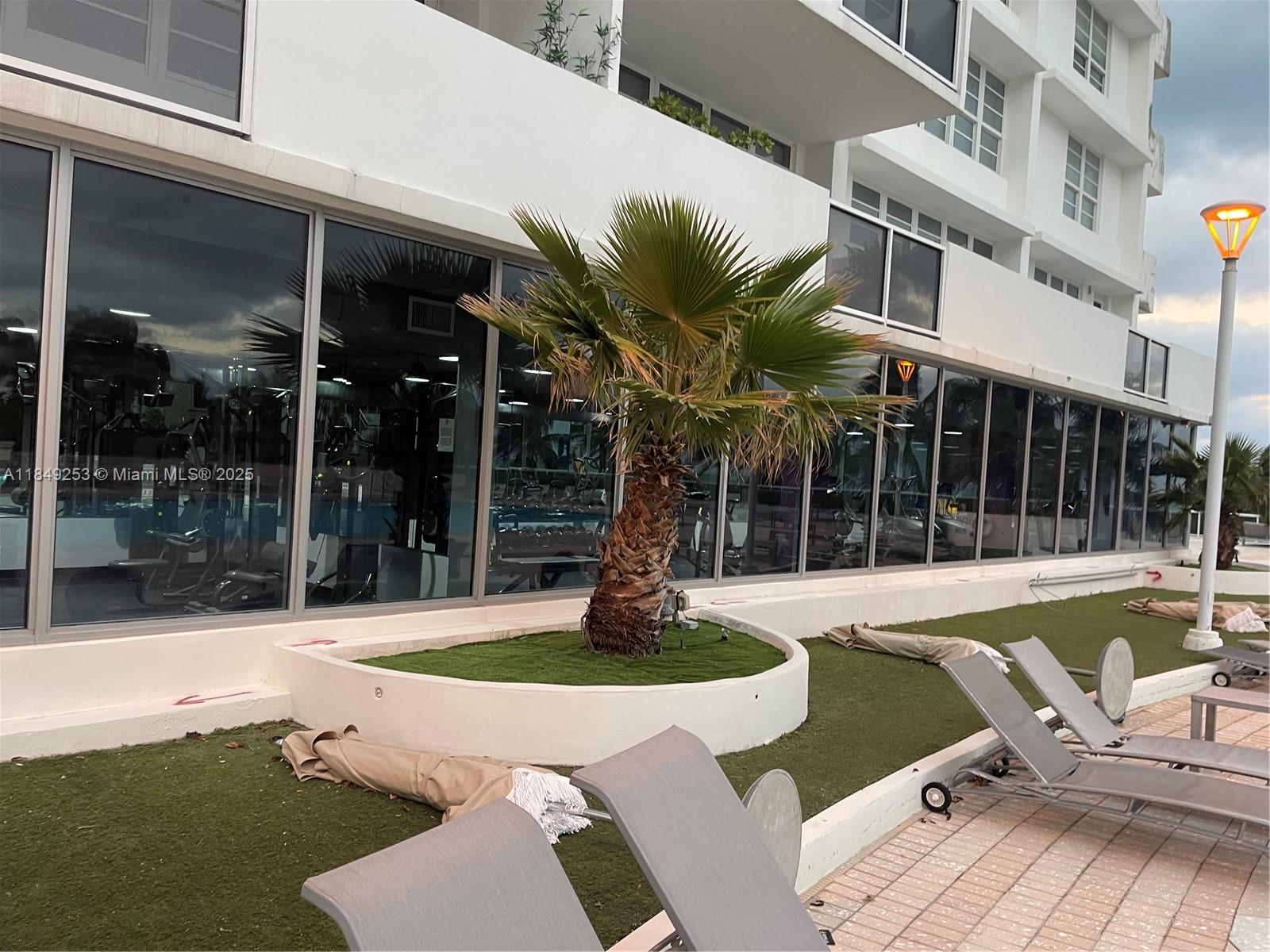 100 Lincoln Road, Unit 833 Miami Beach, FL 33139 - Photo 23 of 30 a view of a house with swimming pool and porch with furniture