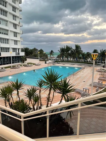a view of swimming pool with outdoor seating and plants