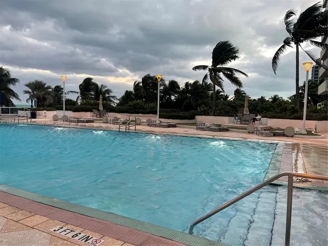 a view of a swimming pool and lounge chair
