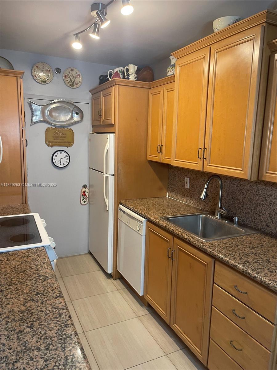 100 Lincoln Road, Unit 833 Miami Beach, FL 33139 - Photo 8 of 30 a kitchen with stainless steel appliances granite countertop a refrigerator and a sink