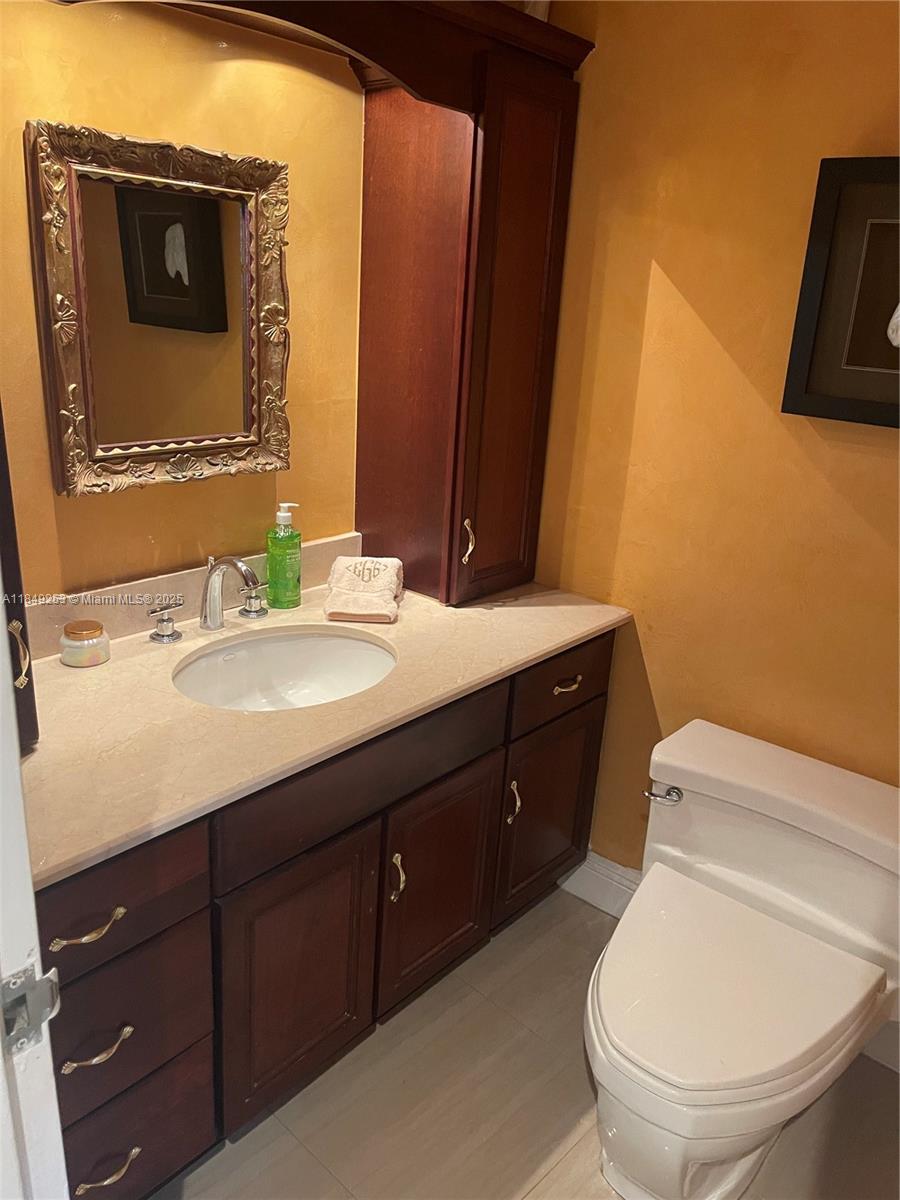 100 Lincoln Road, Unit 833 Miami Beach, FL 33139 - Photo 10 of 30 a bathroom with a toilet sink vanity and mirror