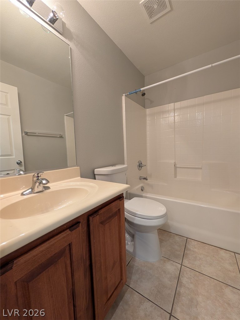 10308 Faustine Avenue Las Vegas, NV 89129 - Photo 18 of 28 A compact bathroom offers essential fixtures and tiled flooring for easy maintenance.