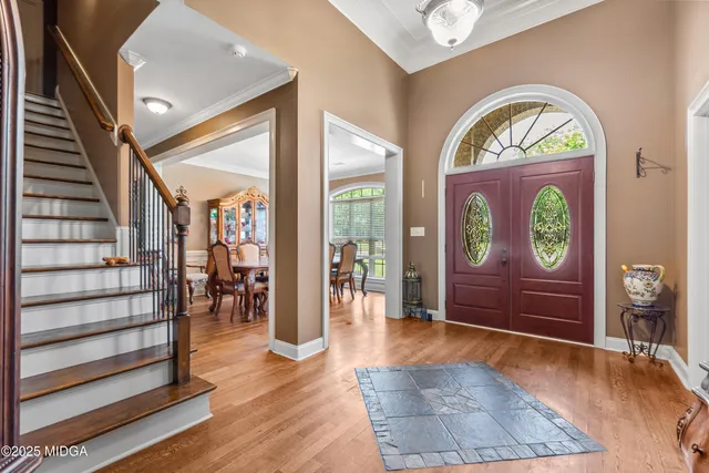 a view of an entryway with wooden floor and a rug