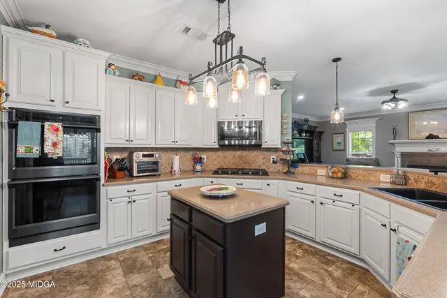 a view of a livingroom with furniture and gym equipment