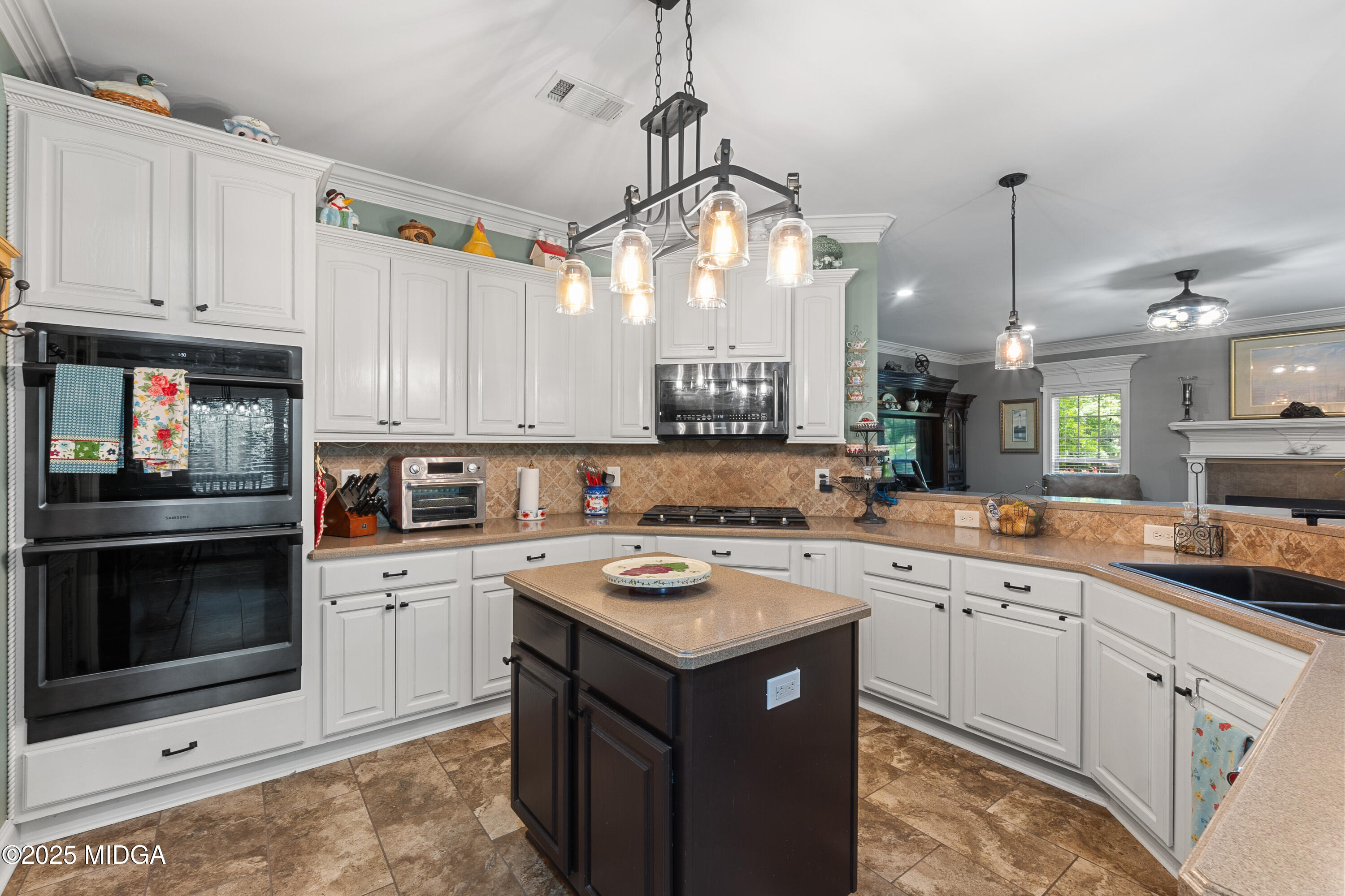 105 River Rock Court Perry, GA 31069 - Photo 26 of 61 a kitchen with a sink a stove and cabinets