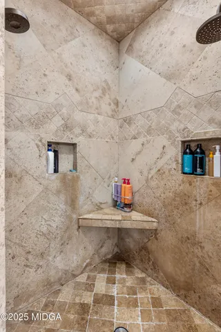 a bathroom with a granite countertop sink a toilet a mirror and shower