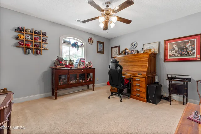 a bathroom with a granite countertop sink a toilet and a mirror