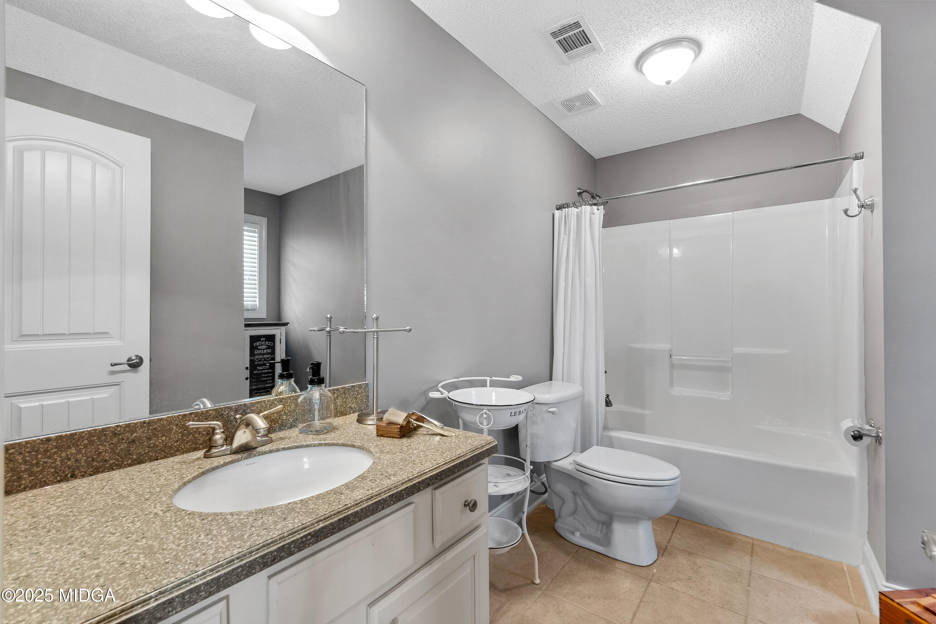 105 River Rock Court Perry, GA 31069 - Photo 42 of 61 a bathroom with a granite countertop sink a toilet a mirror and shower