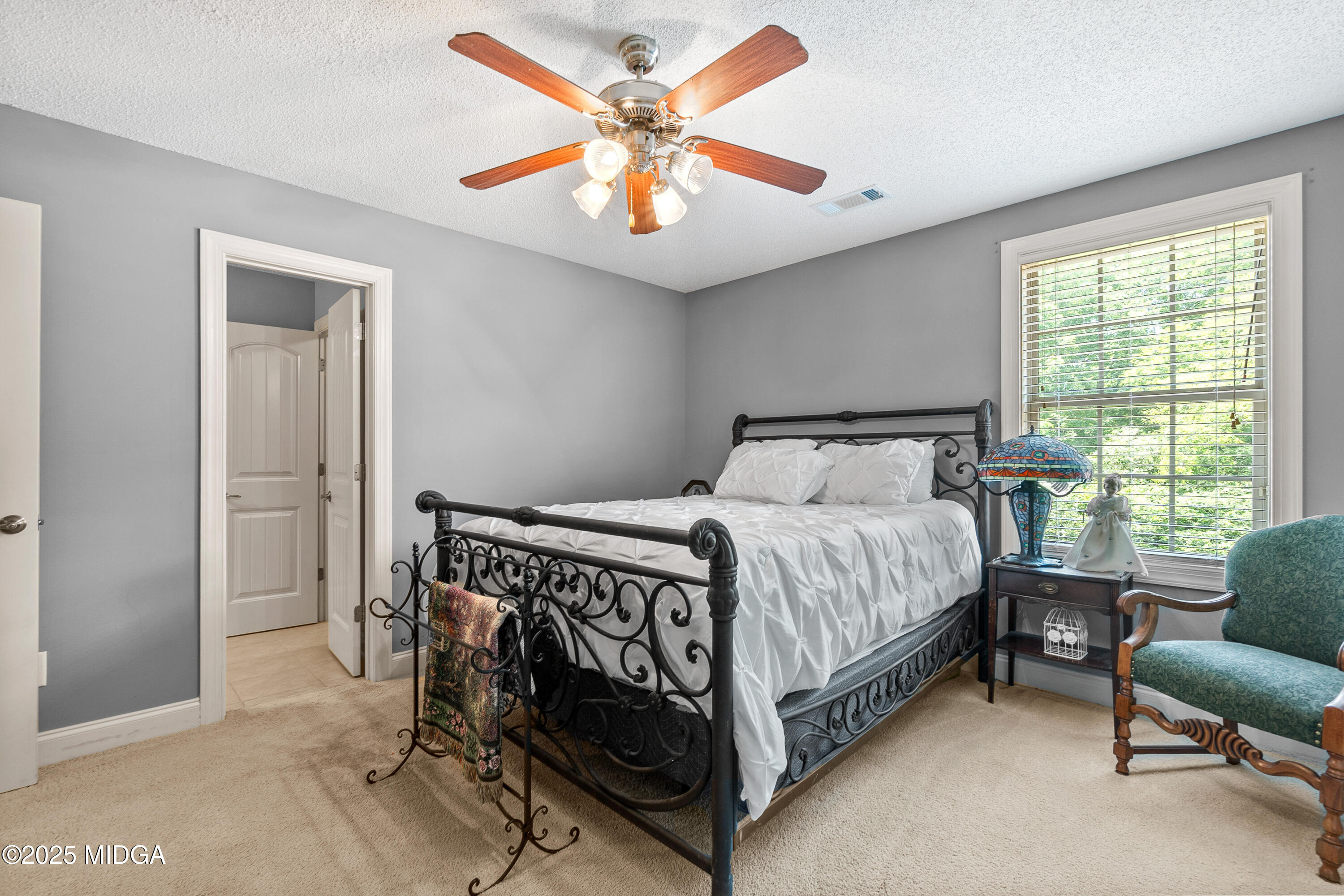 105 River Rock Court Perry, GA 31069 - Photo 44 of 61 a bed sitting in a bedroom next to a window