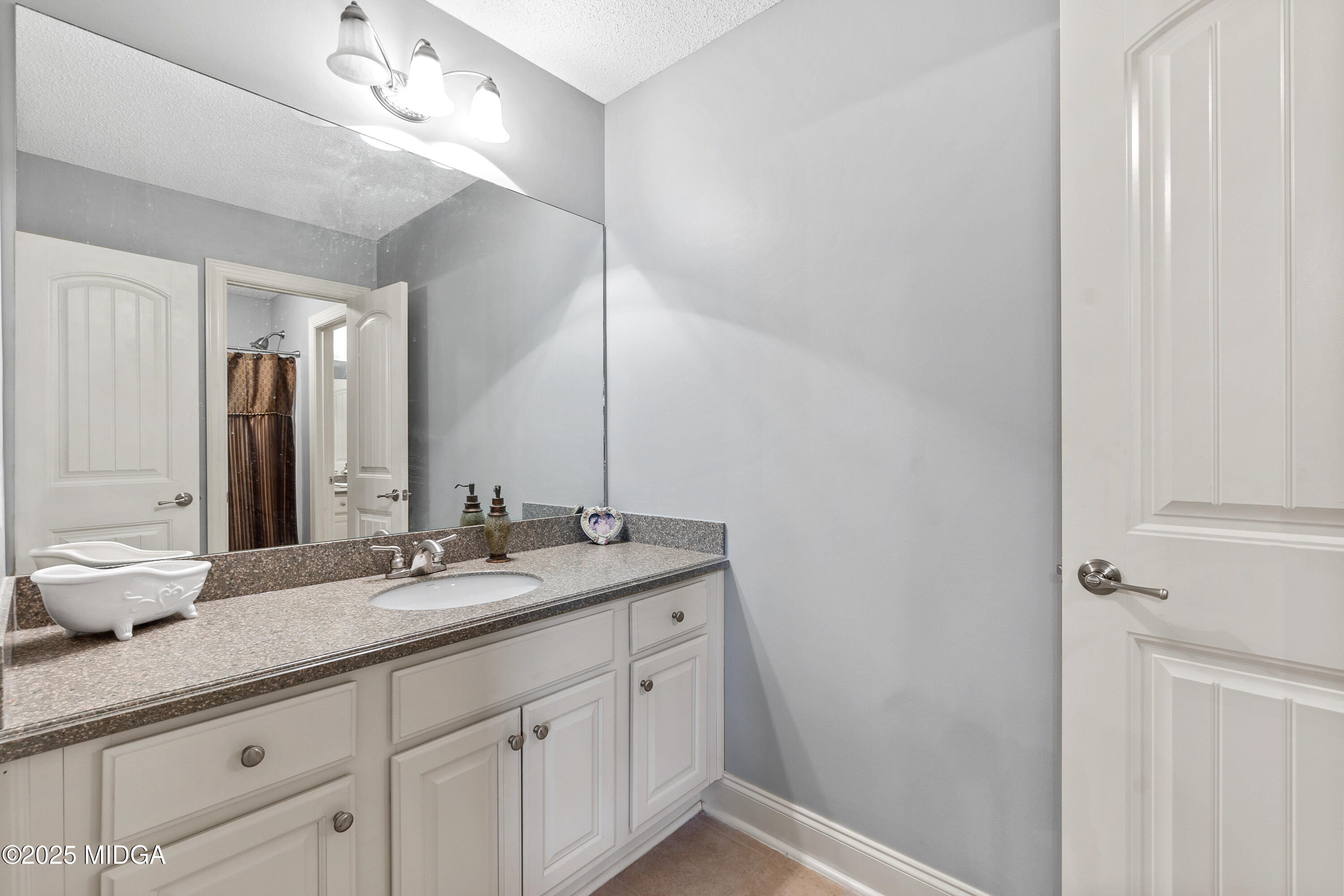 105 River Rock Court Perry, GA 31069 - Photo 45 of 61 a bathroom with a double vanity sink and a mirror