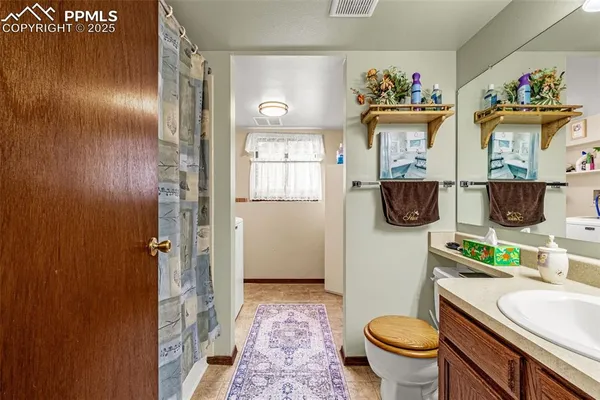 a bathroom with a sink mirror toilet and shower