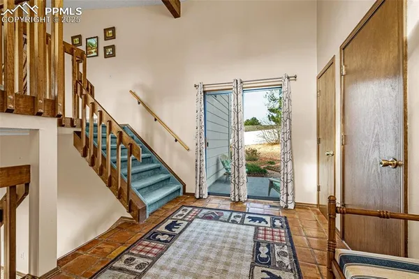a view of an entryway with wooden floor and door