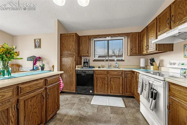 a kitchen with a sink stove and cabinets