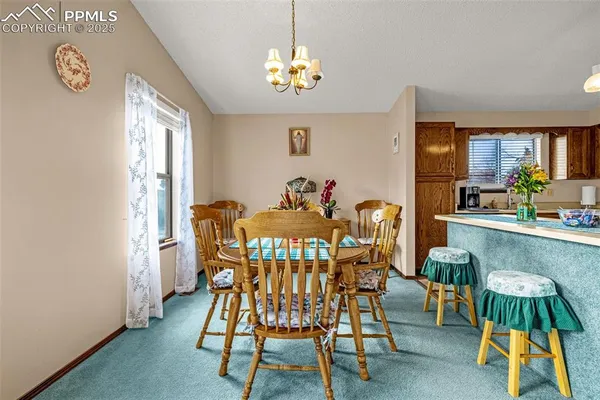 a view of a dining room with furniture window and outside view