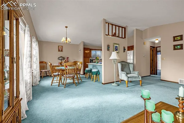 a living room filled with furniture and a chandelier