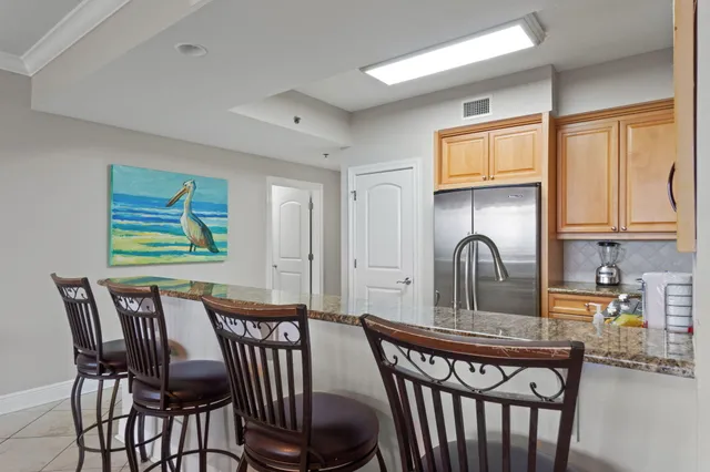 a kitchen with stainless steel appliances granite countertop a stove a sink and a refrigerator