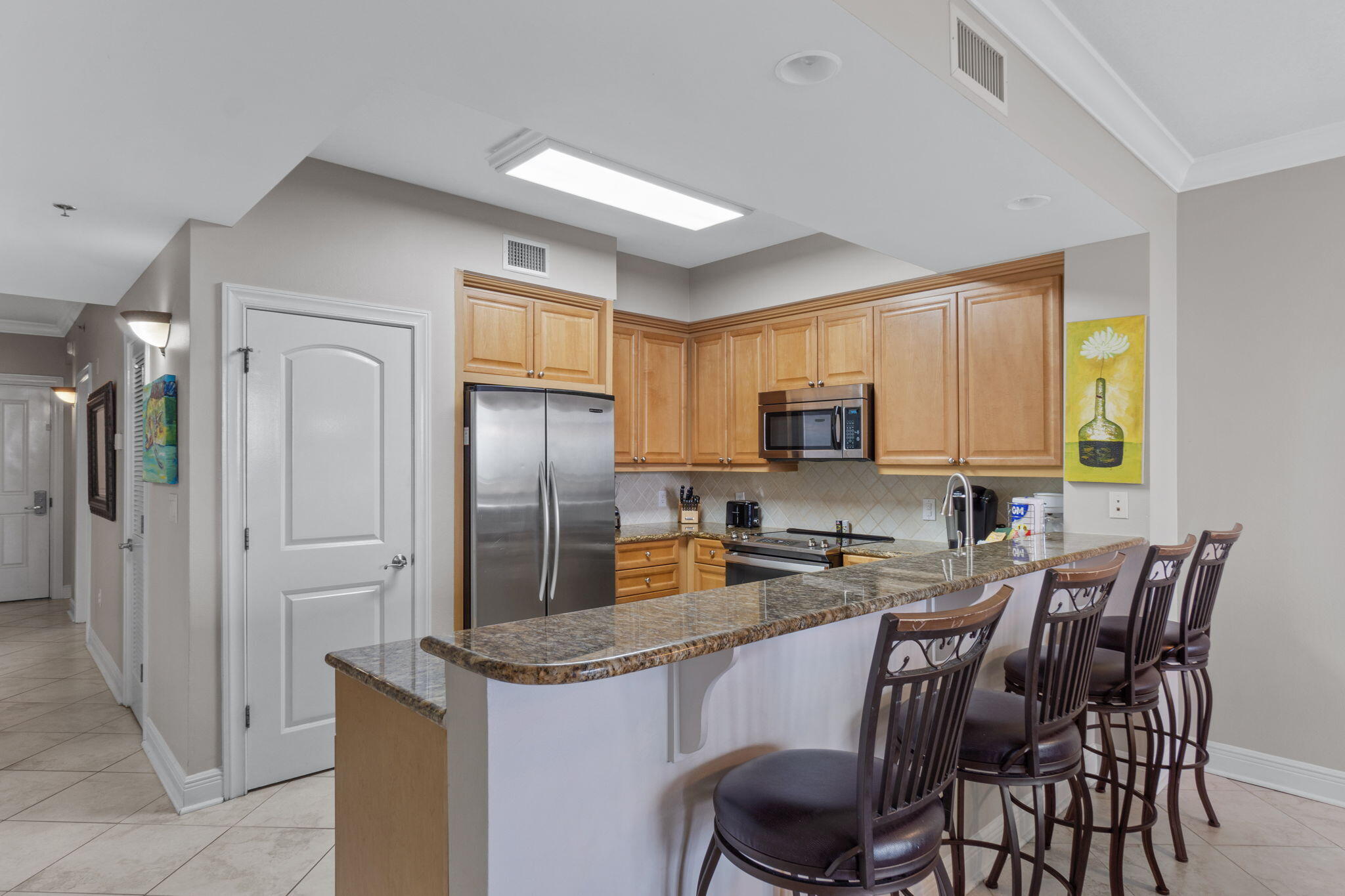 1150 Santa Rosa Boulevard, Unit 113 Fort Walton Beach, FL 32548 - Photo 17 of 71 a kitchen with stainless steel appliances granite countertop a stove a refrigerator a sink a dining table and chairs