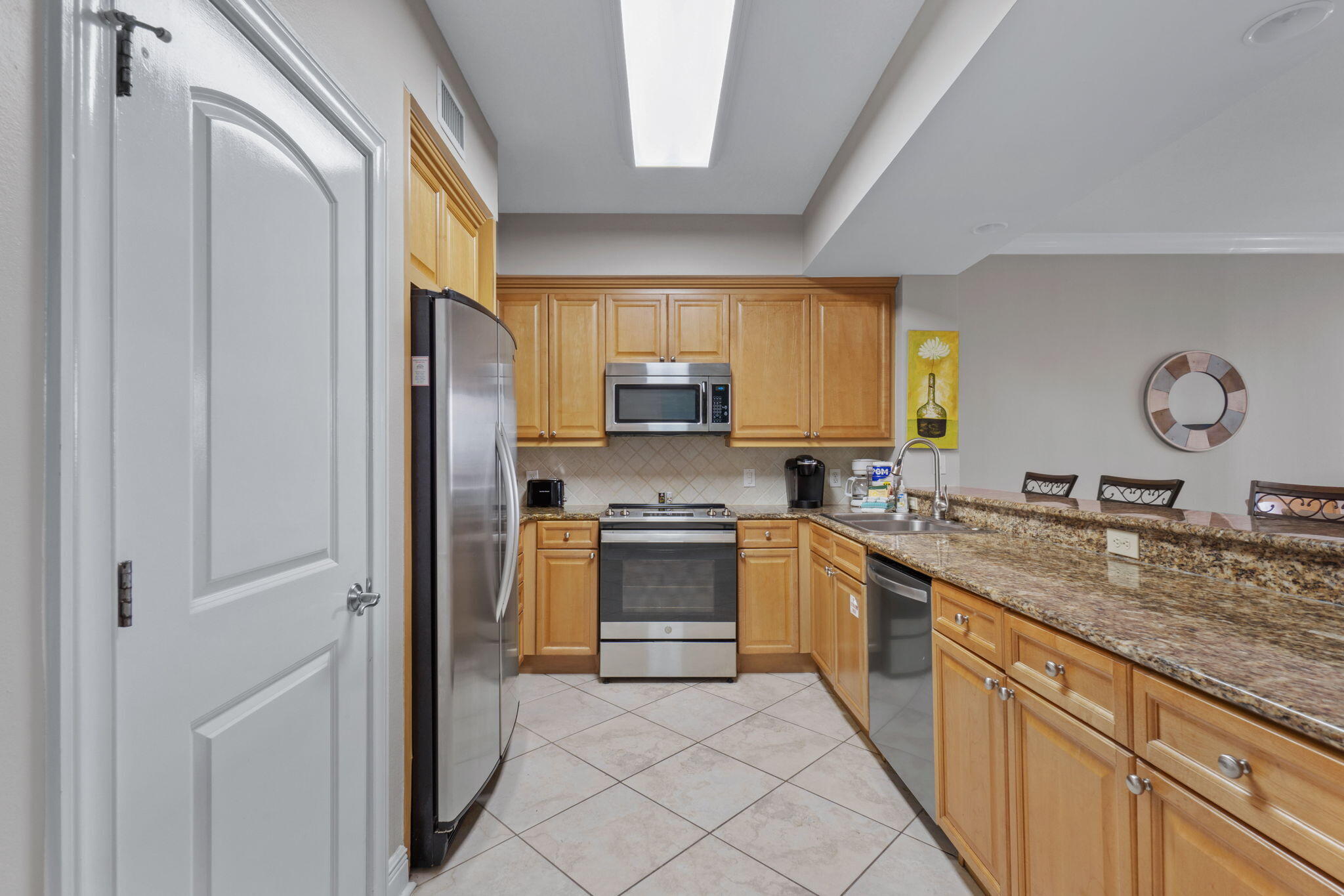 1150 Santa Rosa Boulevard, Unit 113 Fort Walton Beach, FL 32548 - Photo 19 of 71 a kitchen with stainless steel appliances granite countertop a stove a sink and a refrigerator